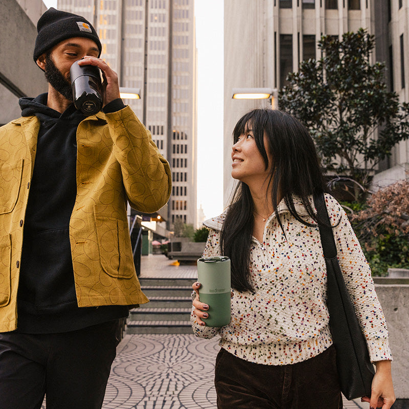 16oz-rise-tumbler-v5 16oz_rise_tumbler_black_iceberg_couple_drink_city_street_square.jpg