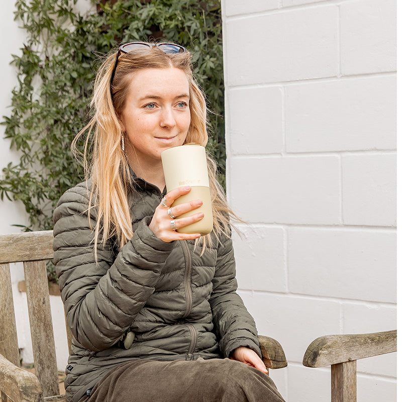 16oz-rise-tumbler-v5 16oz_rise_tumbler_wax_yellow_woman_seat_outside_square.jpg