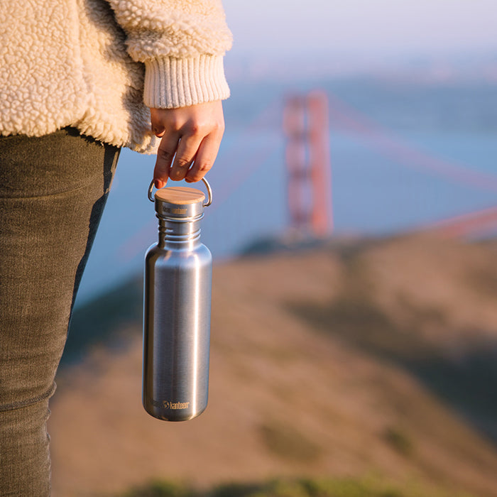 27oz-reflect-with-bamboo-cap-e6 K27SSLRF-BS-BAMBOO_reflect_bottle_bridge_lifestyle.jpg