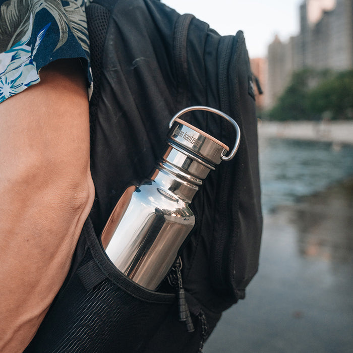 27oz-reflect-with-bamboo-cap-e6 K27SSLRF-MS-BAMBOO_reflect-bottle_backpack_lifestyle.jpg